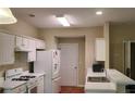 Bright kitchen with white cabinets, modern appliances, and a breakfast bar for casual dining at 4208 Royal Regency Nw Cir # 9, Kennesaw, GA 30144