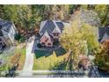 Aerial view of a lovely home with a tree-lined yard at 445 Big Bend Trl, Sugar Hill, GA 30518
