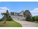 Exterior view showcasing the two-car garage and driveway at 639 Puckett Se Rd, Emerson, GA 30137