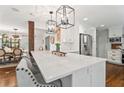 Bright, updated kitchen with an island, pendant lighting, white cabinets and stainless steel appliances at 10 Wyndham Dr, Sandy Springs, GA 30328