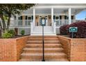Welcoming front entrance with classic brick steps, a covered porch, and address plaque at 110 Apple Blossom Ln, Fayetteville, GA 30215