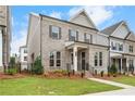 Elegant brick home with a covered entryway, showcasing its well-maintained landscaping and curb appeal at 146 Birch Tree Way, Cumming, GA 30040