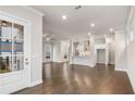 Bright, open-concept living area leading into a kitchen, featuring hardwood floors and recessed lighting at 146 Birch Tree Way, Cumming, GA 30040