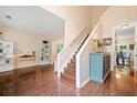 Bright open-concept living room and staircase with beautiful hardwood floors and neutral decor at 160 Wentworth Dr, Canton, GA 30114