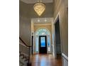 Elegant foyer with a stunning chandelier, arched doorway, and hardwood floors at 370 Buchanan Circle Tract 1, Dallas, GA 30157