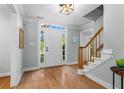 Bright foyer with hardwood floors, staircase with wooden railing, and a front door with sidelights at 4794 Dalhousie Ne Pl, Marietta, GA 30068