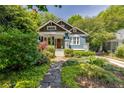 Charming craftsman-style home with blue exterior, inviting front porch, and beautiful landscaping at 342 5Th Ne St, Atlanta, GA 30308