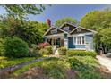 Charming home exterior featuring a well-manicured lawn and a welcoming front porch at 342 5Th Ne St, Atlanta, GA 30308
