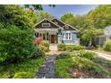 Charming home exterior featuring a well-manicured lawn and a welcoming front porch at 342 5Th Ne St, Atlanta, GA 30308