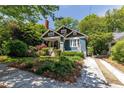 Charming home exterior featuring a well-manicured lawn and a welcoming front porch at 342 5Th Ne St, Atlanta, GA 30308