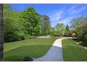 Expansive front yard with lush green lawn and a winding walkway leading to the home at 3590 Fricks Rd, Marietta, GA 30062