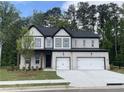 Charming two-story home featuring a brick exterior, a well-manicured lawn and an attached garage at 1994 Freestone Way, Marietta, GA 30064