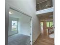 Hallway view with hardwood flooring, two story entry and view to a carpeted room through a doorway at 1994 Freestone Way, Marietta, GA 30064