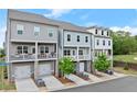 Row of three story townhomes, showcasing stone foundations and private balconies at 2110 Prichard Park Dr, Kennesaw, GA 30144