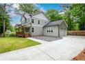 Two-story home with a two-car garage and long driveway, enhanced with a wooden fence at 2805 Pineland Ave, Atlanta, GA 30340