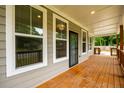 Covered front porch featuring wood floors, wood railing, and multiple windows at 2805 Pineland Ave, Atlanta, GA 30340