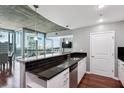 Kitchen with granite countertops, white cabinets, a black backsplash, and an attached seating area overlooking city views at 3324 Peachtree Rd # 1719, Atlanta, GA 30326