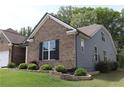 A well-maintained single-Gathering home featuring a blend of brick and siding, complemented by a green lawn and landscaping at 3630 Deaton Trl, Buford, GA 30519