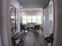 Open-concept living room with hardwood floors, large windows, and stylish furniture, seamlessly connected to other areas at 3630 Deaton Trl, Buford, GA 30519