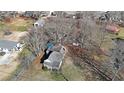 Aerial view of a home showcasing the roof, backyard and surrounding trees at 2651 Old Lost Mountain Rd, Powder Springs, GA 30127