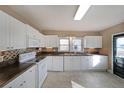 Bright kitchen with white cabinets, stainless steel appliances, and ample counter space for meal preparation at 2651 Old Lost Mountain Rd, Powder Springs, GA 30127