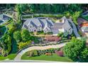 Expansive home with meticulously landscaped grounds and circular driveway at 5004 Gunnison Trce, Suwanee, GA 30024