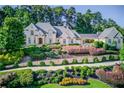 Beautiful home with terraced landscaping and elegant architectural details at 5004 Gunnison Trce, Suwanee, GA 30024