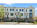 Charming townhouses with brick and white exteriors, black framed windows, and well-maintained landscaping at 2872 Evanshire Ave # 116, Duluth, GA 30096