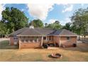 Brick home exterior features a back patio, deck, and fire pit area for outdoor enjoyment at 1030 E Lakehaven Way, Mcdonough, GA 30253