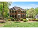Charming brick residence with symmetrical facade and lush front yard landscaping at 4423 Windsor Oaks Cir, Marietta, GA 30066