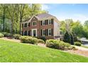 Two-story house with well-maintained yard and manicured shrubbery at 4423 Windsor Oaks Cir, Marietta, GA 30066