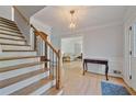 Light-filled foyer featuring hardwood floors, staircase, and elegant lighting at 4423 Windsor Oaks Cir, Marietta, GA 30066