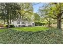 Quaint home with black shutters and lush landscaping providing privacy at 502 Allgood Ne Rd, Marietta, GA 30060