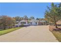 Charming one-story home featuring a covered carport, a brick chimney and a long cracked driveway at 6684 Birch Rd, Winston, GA 30187