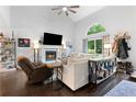 Inviting living room features a fireplace, hardwood floors, neutral decor, and ceiling fan at 100 Karla Ct, Roswell, GA 30076