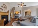 Cozy living room featuring a fireplace, wood floors, and an open layout leading into kitchen at 327 Stone Valley Xing, Canton, GA 30114