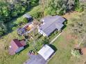 Aerial view of the property featuring a large backyard, outbuildings, and mature trees at 1025 Rocky Plains Rd, Covington, GA 30016