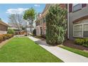 Lovely townhouses, green lawns and a concrete sidewalk at 10686 Austen Bnd, Alpharetta, GA 30022