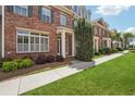 Beautiful townhouses with manicured lawns and sidewalks on a sunny day at 10686 Austen Bnd, Alpharetta, GA 30022