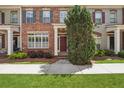 Attractive brick townhouse featuring a well-manicured lawn and landscaped garden at 10686 Austen Bnd, Alpharetta, GA 30022