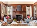 Elegant living room boasts rich wood paneling, a cozy fireplace, and stylish furnishings, perfect for relaxation at 1585 S Ponce De Leon Ne Ave # 20, Atlanta, GA 30307