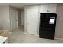 Kitchen area featuring a new refrigerator, matching upper cabinets, and laminate flooring at 2657 Mcguire Nw Dr, Kennesaw, GA 30144
