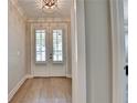 Bright foyer featuring hardwood floors and double doors with plantation shutters at 3460 Montebello Pkwy, Cumming, GA 30028