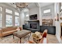Stylish living room with fireplace, hardwood floors, and large windows allowing ample natural light at 3460 Montebello Pkwy, Cumming, GA 30028