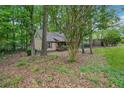Exterior of a cozy home surrounded by lush trees and greenery, offering privacy at 6693 Doublegate Ln, Rex, GA 30273