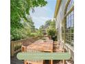 Enjoy the views from this spacious deck with a wooden table and wicker chairs overlooking the gorgeous yard at 1354 Benbrooke Nw Ln, Acworth, GA 30101