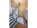 Elegant foyer featuring a grand staircase, chandelier, and hardwood floors at 1354 Benbrooke Nw Ln, Acworth, GA 30101