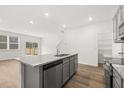 Open concept kitchen with gray cabinets, stainless appliances, and a view to the living area at 229 Kenoot Dr # 49, Mcdonough, GA 30253