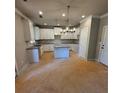 The large kitchen features granite countertops, white cabinets and stainless steel appliances at 3089 Corbin Ave, Decatur, GA 30034