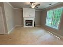 This cozy living room showcases a fireplace, crown molding, and a large window at 3089 Corbin Ave, Decatur, GA 30034